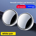 A small round car rearview mirror with a suction cup