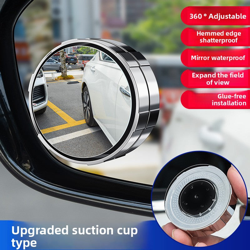 A small round car rearview mirror with a suction cup